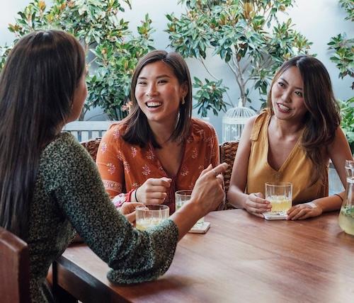 group of friends chatting while having drinks