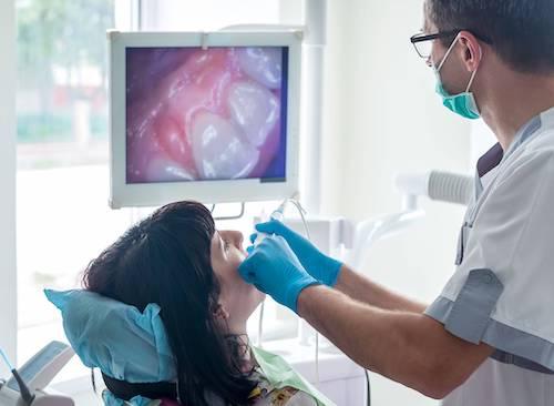 dentist using intraoral camera