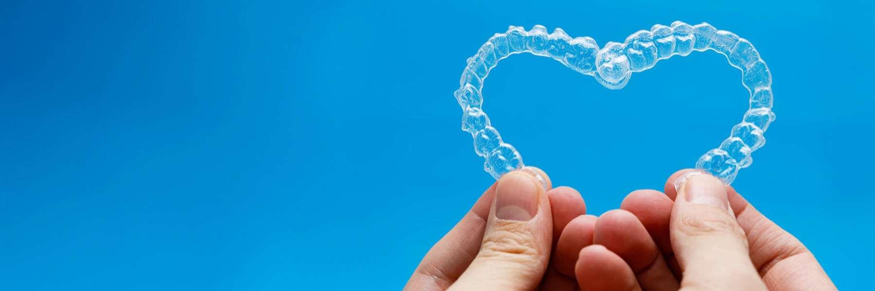 hand holding clear aligners