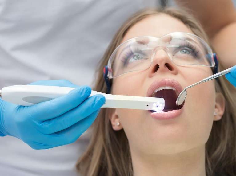patient having Intraoral Camera used during dental procedure
